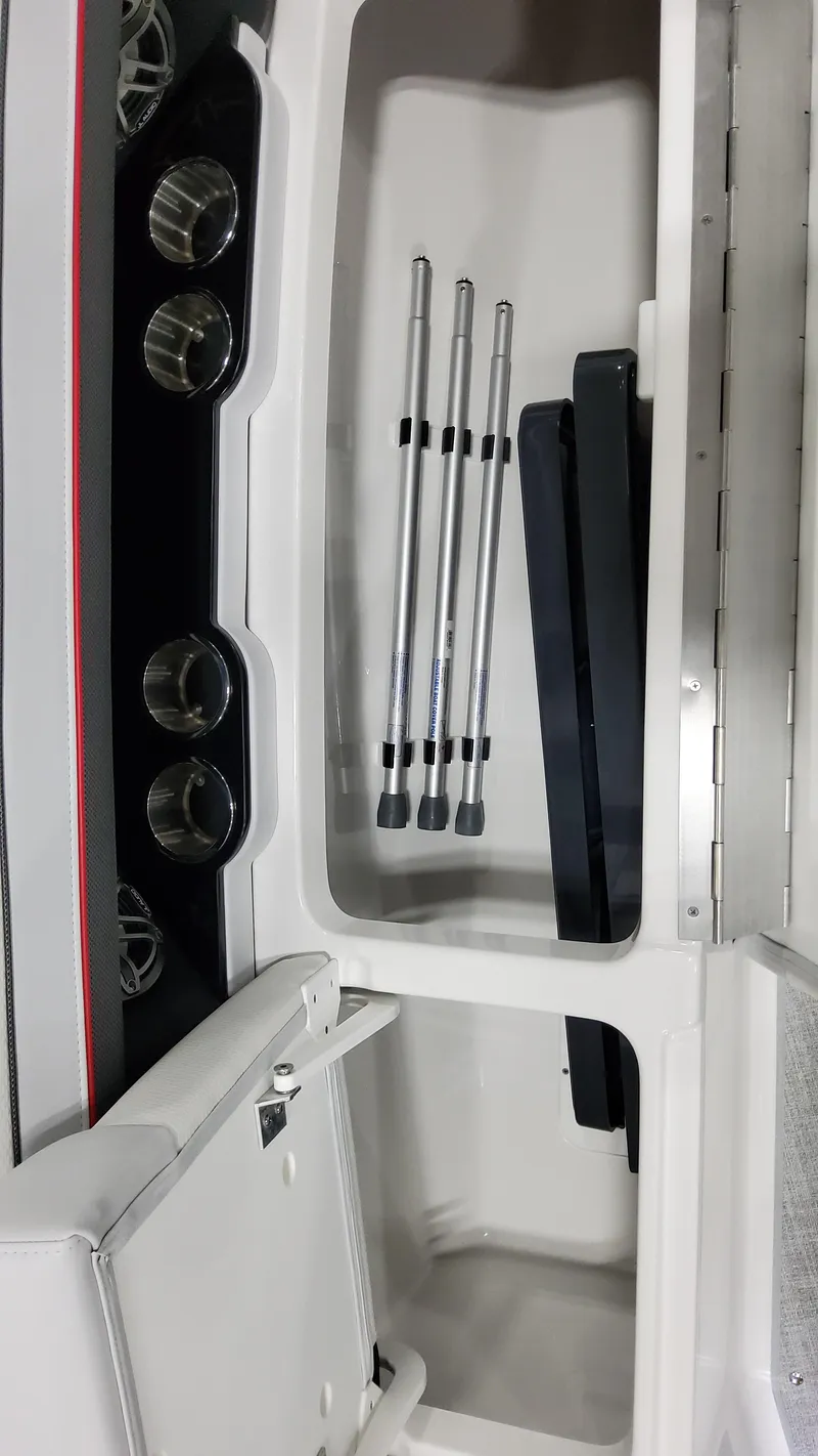 Slide: The Image of 2025 Formula 350 Crossover Bowrider I/O storage compartment with cup holders and poles. - 37