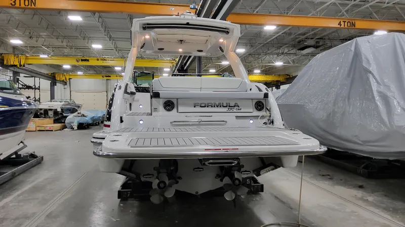 Slide: The Image of 2025 Formula 350 Crossover Bowrider I/O in a warehouse setting, rear view. - 4
