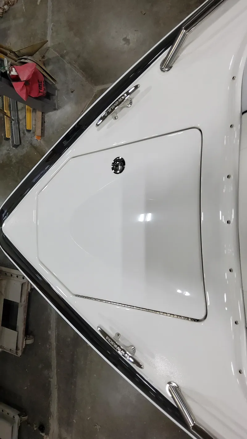 Slide: The Image of 2025 Formula 350 Crossover Bowrider I/O, sleek white bow design, docked indoors. - 43