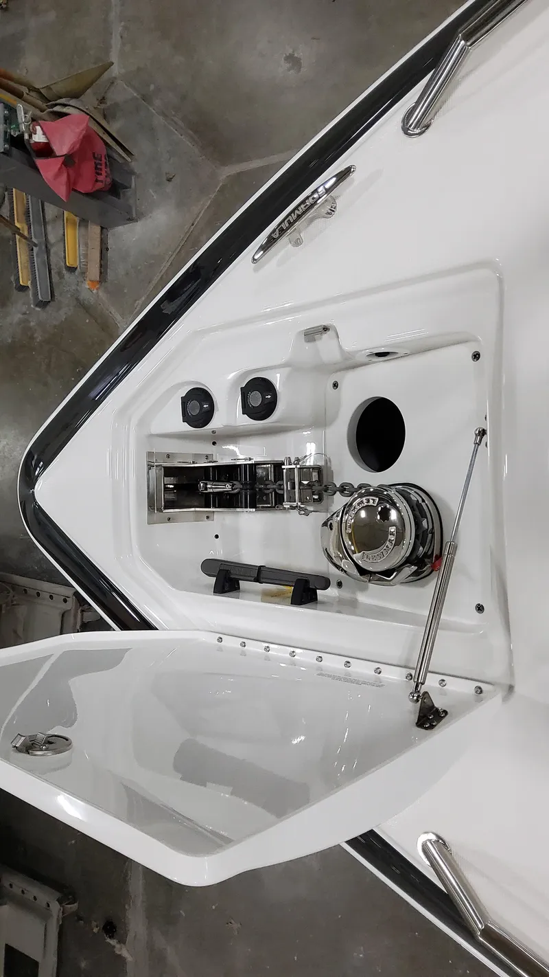 Slide: The Image of 2025 Formula 350 Crossover Bowrider I/O boat deck with open storage compartment. - 44