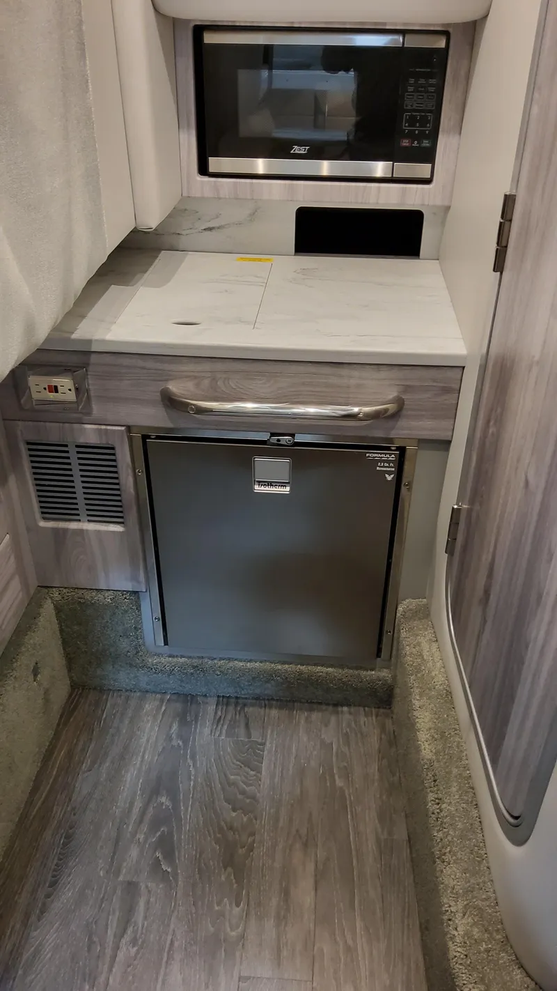 Slide: The Image of 2025 Formula 350 Crossover Bowrider I/O interior with microwave and mini-fridge. - 47