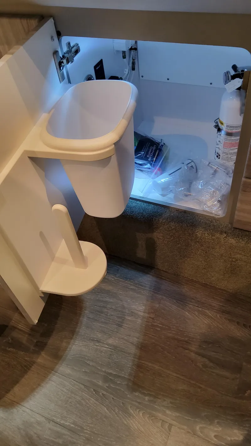 Slide: The Image of 2025 Formula 350 Crossover Bowrider I/O interior storage with trash bin and fire extinguisher. - 49