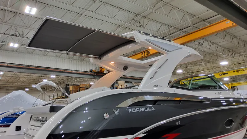 Slide: The Image of 2025 Formula 350 Crossover Bowrider I/O in a showroom, showcasing sleek design and modern features. - 5