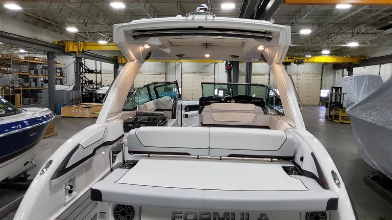 Slide: The Image of 2025 Formula 350 Crossover Bowrider I/O in a warehouse setting, showcasing its sleek design. - 9