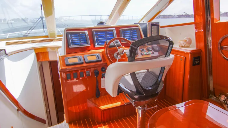 Slide: The Image of Luxurious 2008 McKinna Pilothouse yacht interior with polished wood and modern navigation equipment. - 15