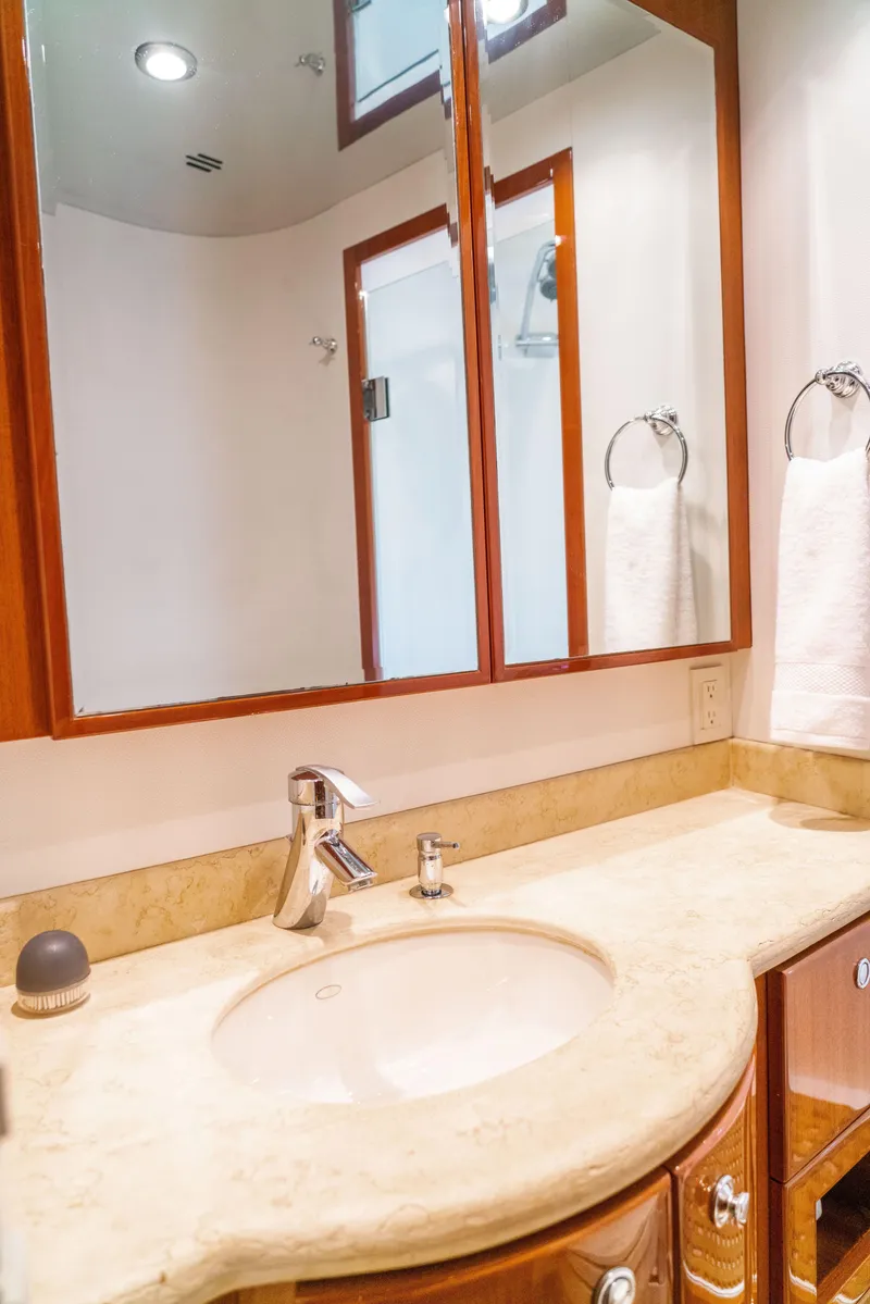 Slide: The Image of 2008 McKinna Pilothouse bathroom with wooden cabinets, mirror, and marble countertop. - 26
