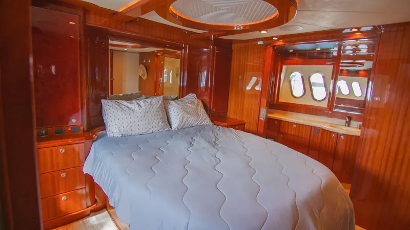 Slide: The Image of Luxurious 2008 McKinna Pilothouse yacht bedroom with elegant wood paneling and cozy bedding. - 28