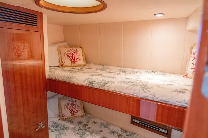 Slide: The Image of 2008 McKinna Pilothouse cabin with bunk beds and coral-themed pillows. - 33