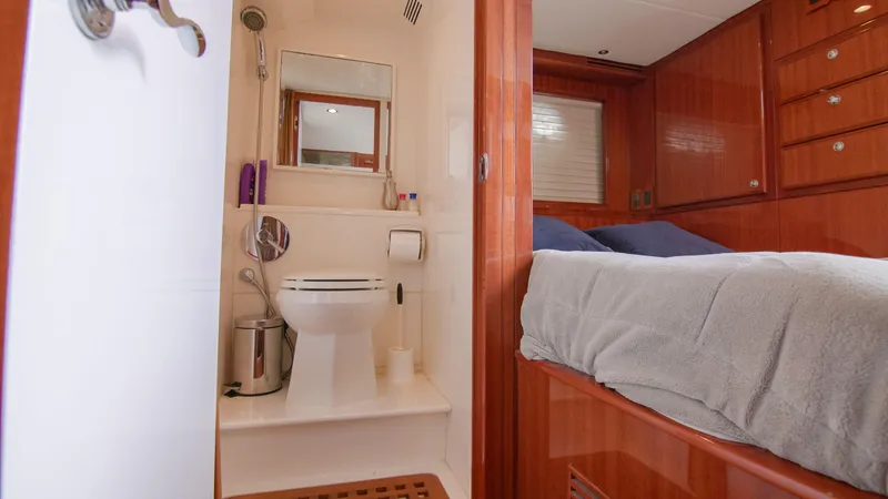 Slide: The Image of 2008 McKinna Pilothouse interior with bathroom and bedroom, featuring wooden cabinetry and modern amenities. - 36