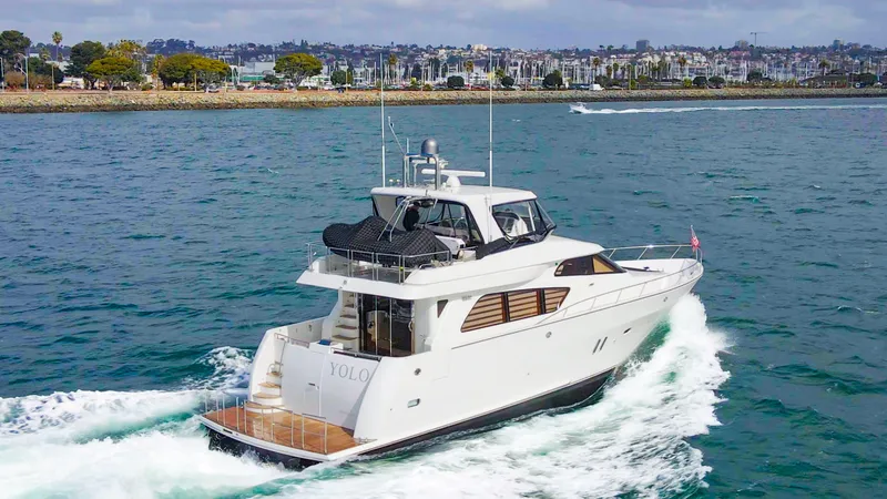 Slide: The Image of 2008 McKinna Pilothouse yacht cruising on open water near a coastal city. - 42