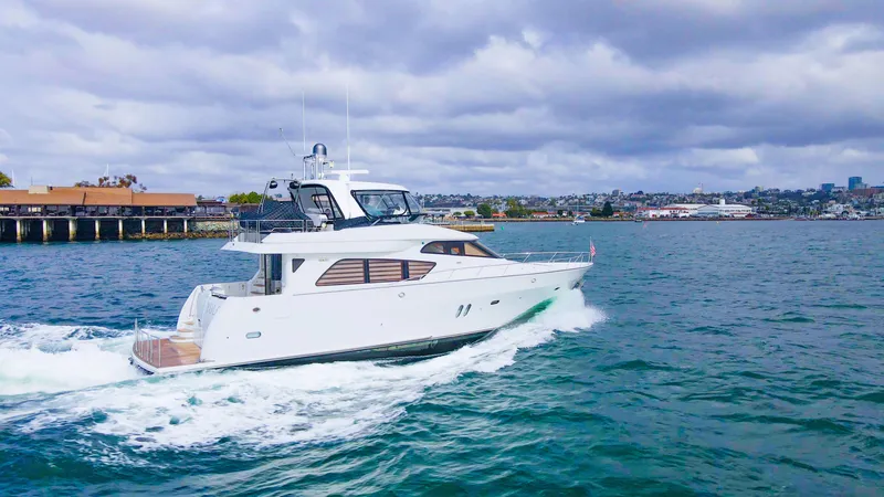 Slide: The Image of 2008 McKinna Pilothouse yacht cruising on a scenic waterway under cloudy skies. - 43