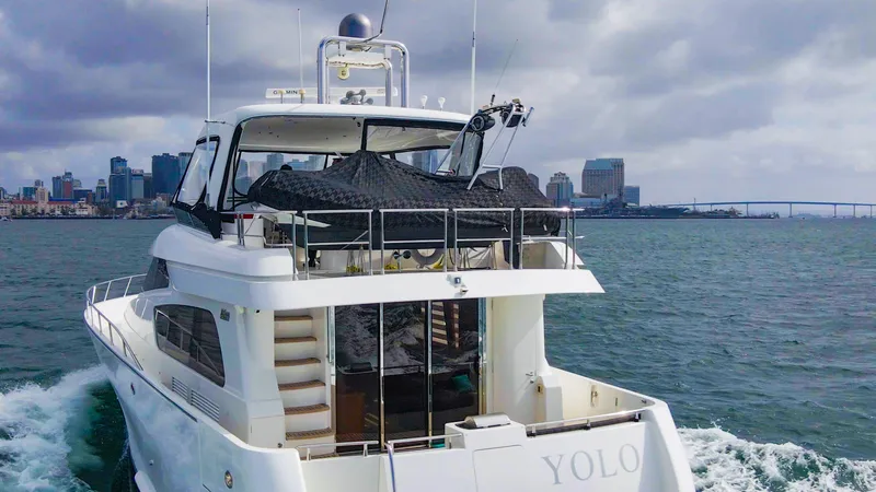 Slide: The Image of 2008 McKinna Pilothouse yacht cruising near city skyline under cloudy skies. - 46