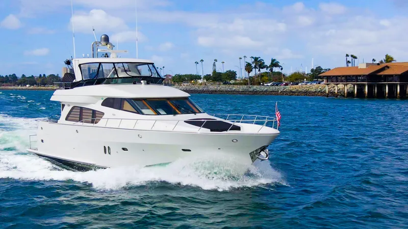 Slide: The Image of 2008 McKinna Pilothouse yacht cruising on blue water near a coastal dock. - 49