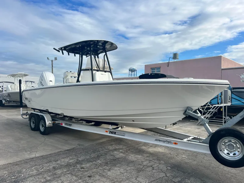 The Image of 2025 Pathfinder 2700 Open boat on trailer, parked outdoors under cloudy sky. - 1