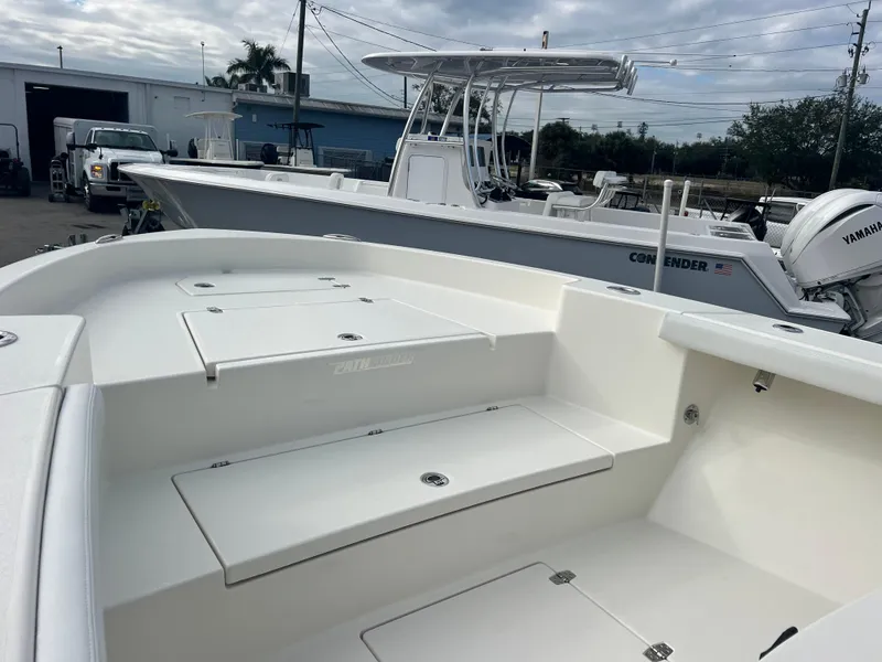 Slide: The Image of 2025 Pathfinder 2700 Open boat, white deck, outdoor marina setting. - 14