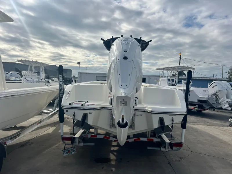 Slide: The Image of 2025 Pathfinder 2700 Open boat on trailer, rear view, cloudy sky background. - 4