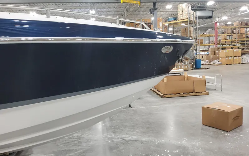 Slide: The Image of 2025 Formula 310 Bowrider OB boat in warehouse setting. - 11