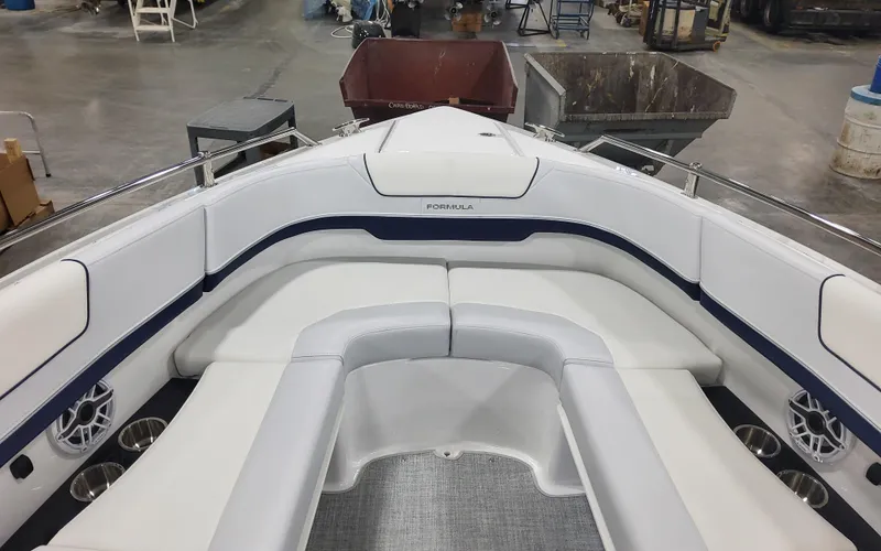 Slide: The Image of 2025 Formula 310 Bowrider OB interior with white seating in a workshop setting. - 14