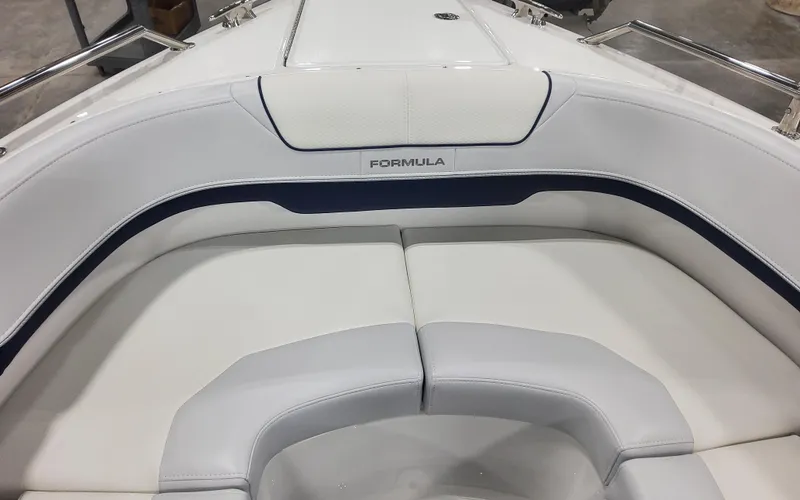 Slide: The Image of 2025 Formula 310 Bowrider OB interior seating, white upholstery with blue accents. - 19
