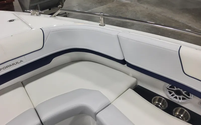 Slide: The Image of 2025 Formula 310 Bowrider OB interior with white seating and speaker detail. - 20