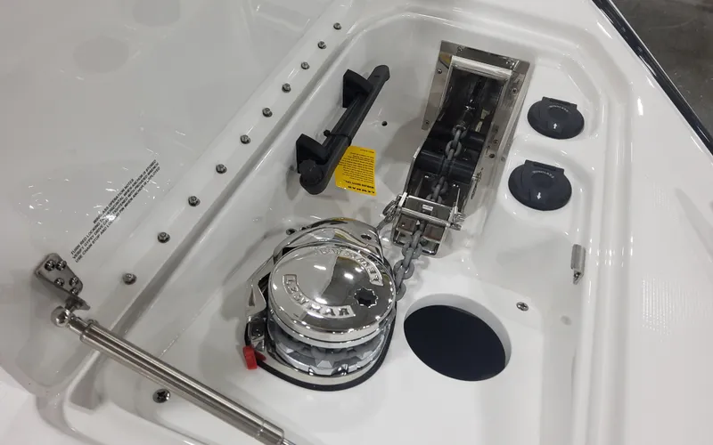 Slide: The Image of 2025 Formula 310 Bowrider OB anchor compartment with winch and chain storage. - 23