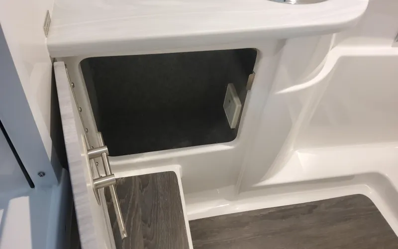 Slide: The Image of 2025 Formula 310 Bowrider OB interior storage compartment with open door. - 30