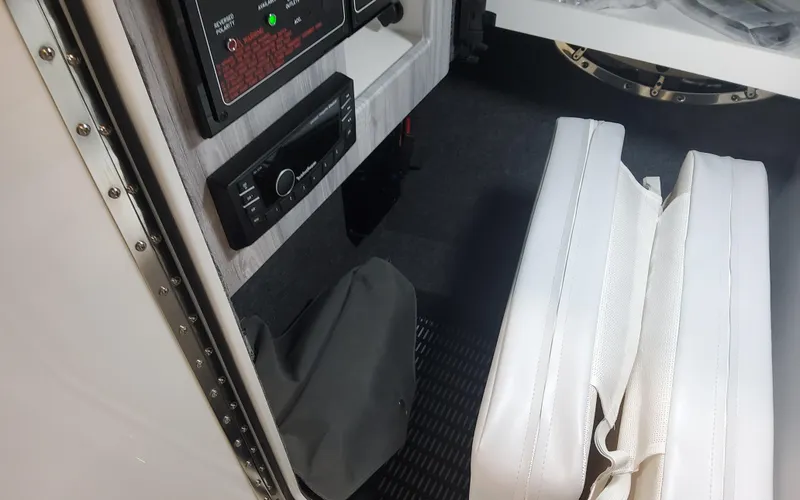 Slide: The Image of Interior of 2025 Formula 310 Bowrider OB, featuring control panel and white seating. - 32