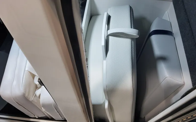 Slide: The Image of 2025 Formula 310 Bowrider OB interior storage with white cushioned seats. - 34