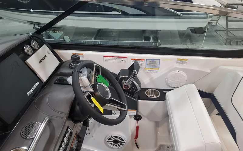 Slide: The Image of 2025 Formula 310 Bowrider OB cockpit with steering wheel and controls. - 38