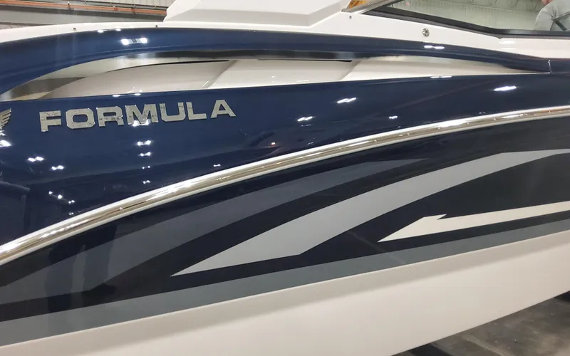 Slide: The Image of 2025 Formula 310 Bowrider OB boat, sleek blue and white design, side view. - 4