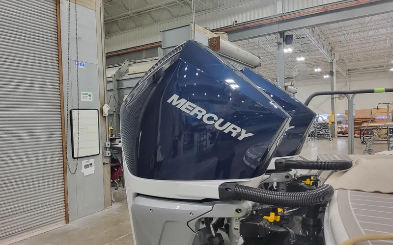 Slide: The Image of 2025 Formula 310 Bowrider OB with Mercury outboard engine in a factory setting. - 5