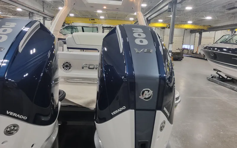 Slide: The Image of 2025 Formula 310 Bowrider OB with twin 300 Verado outboard engines in a showroom. - 9