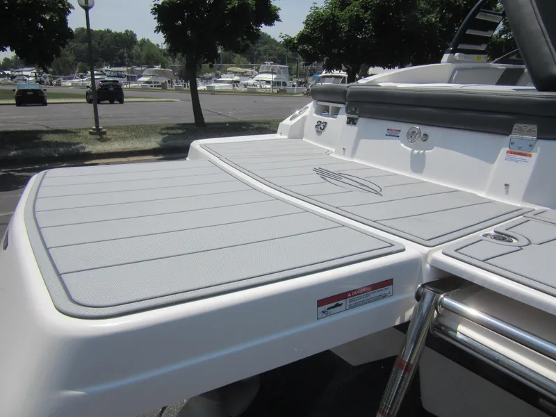 Slide: The Image of 2025 Chaparral 23 SSi boat swim platform with sleek design and ladder. - 11