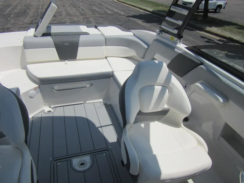 Slide: The Image of 2025 Chaparral 23 SSi boat interior with white seating and gray flooring. - 17