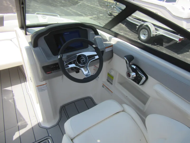 Slide: The Image of 2025 Chaparral 23 SSi boat cockpit with steering wheel and controls. - 19