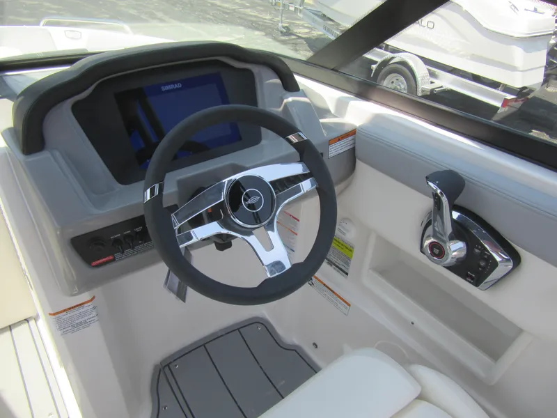 Slide: The Image of 2025 Chaparral 23 SSi boat dashboard with steering wheel and control panel. - 20