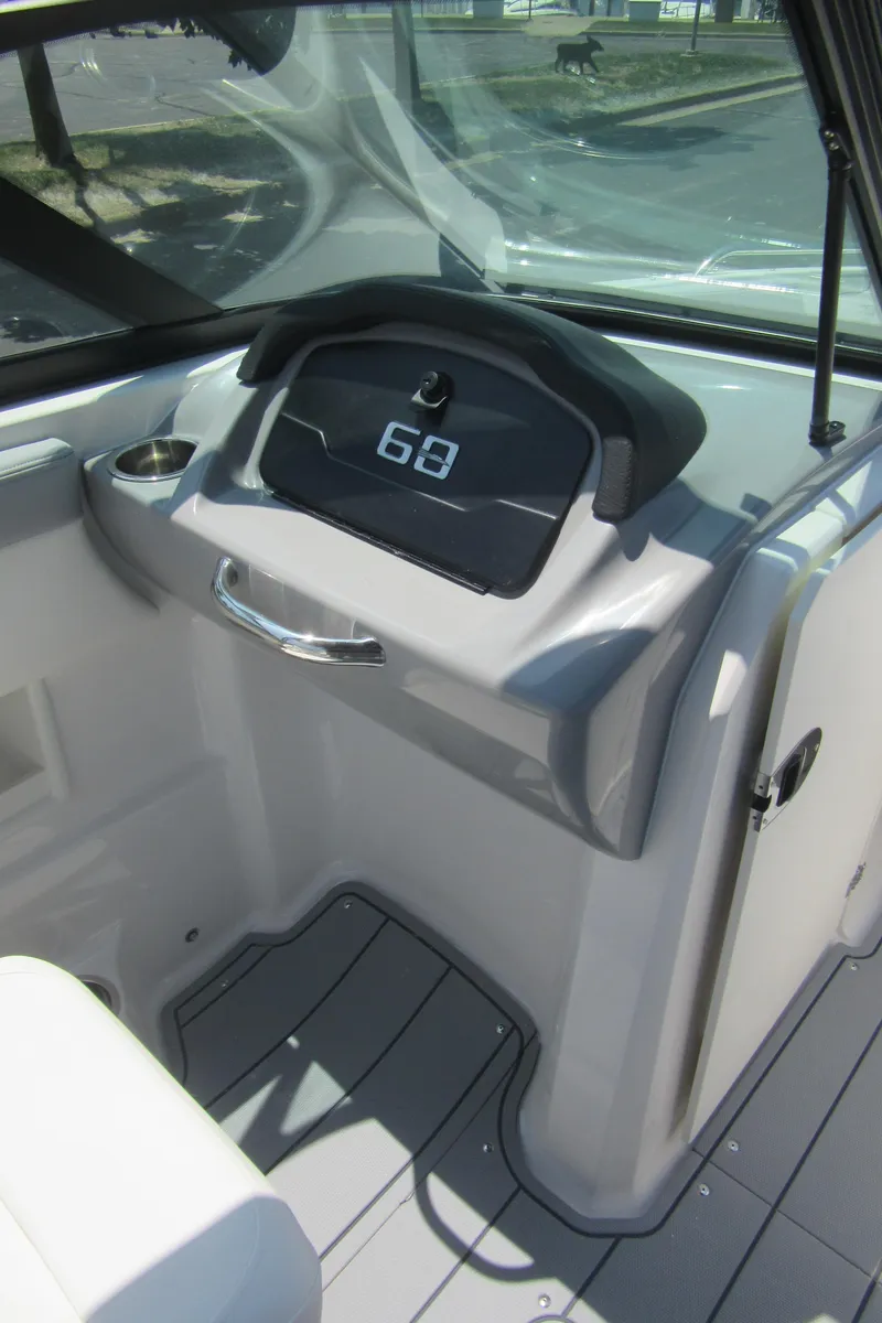 Slide: The Image of 2025 Chaparral 23 SSi boat dashboard with digital display and sleek design. - 26
