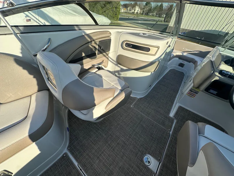 Slide: The Image of 2019 Crownline Eclipse E235 XS boat interior with seating and carpeted flooring. - 11