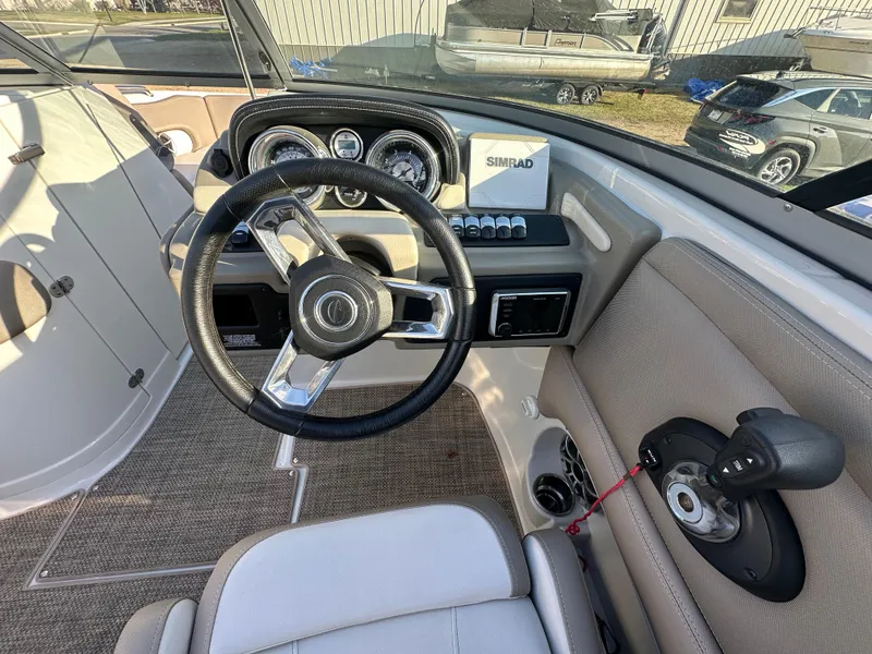 Slide: The Image of 2019 Crownline Eclipse E235 XS boat cockpit with steering wheel and dashboard controls. - 13