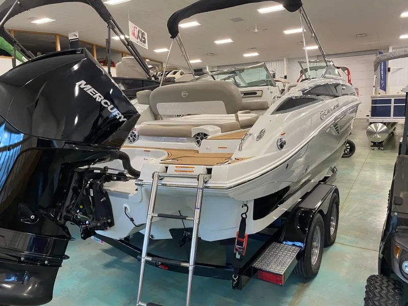 Slide: The Image of 2019 Crownline Eclipse E235 XS boat with Mercury engine on trailer in showroom. - 14