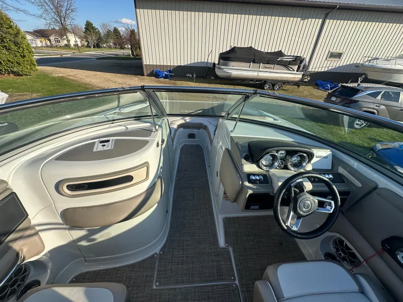 Slide: The Image of 2019 Crownline Eclipse E235 XS boat interior with steering wheel and seating area. - 15