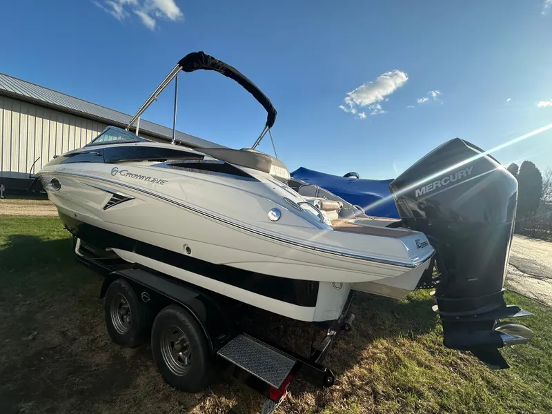 Slide: The Image of 2019 Crownline Eclipse E235 XS boat with Mercury outboard engine on trailer. - 2