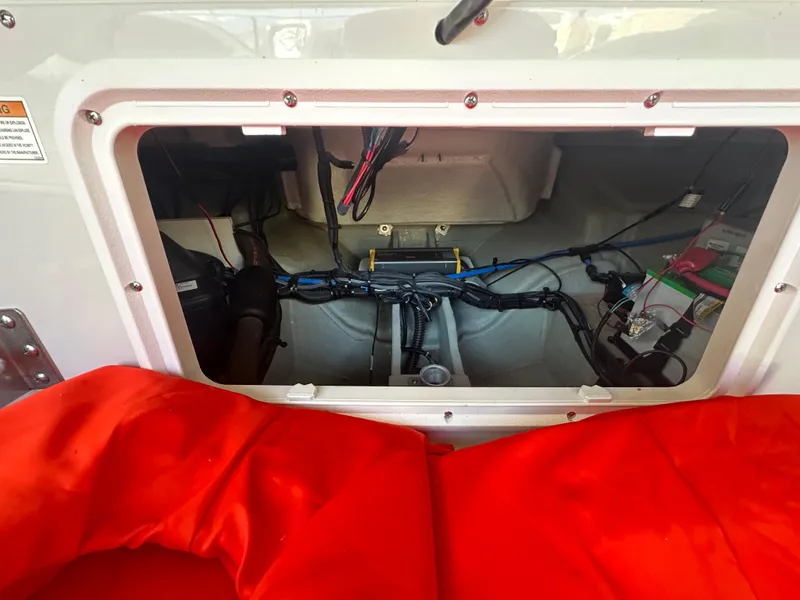 Slide: The Image of 2019 Crownline Eclipse E235 XS boat interior wiring and storage compartment. - 21