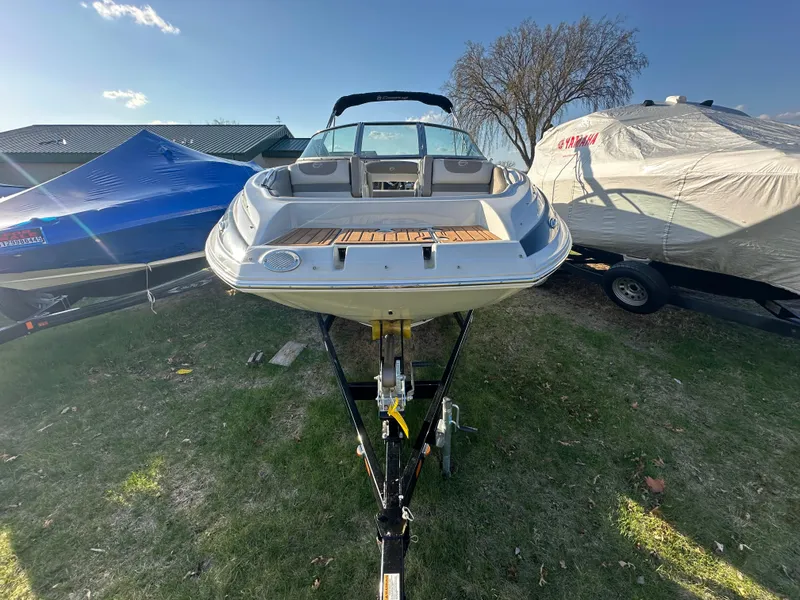 Slide: The Image of 2019 Crownline Eclipse E235 XS boat on trailer, parked outdoors. - 4