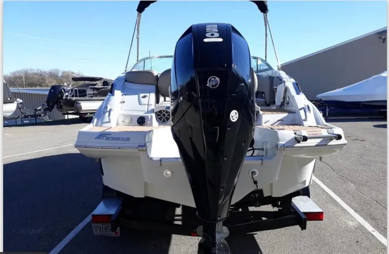 Slide: The Image of 2019 Crownline Eclipse E235 XS boat with outboard motor, parked in a marina. - 7