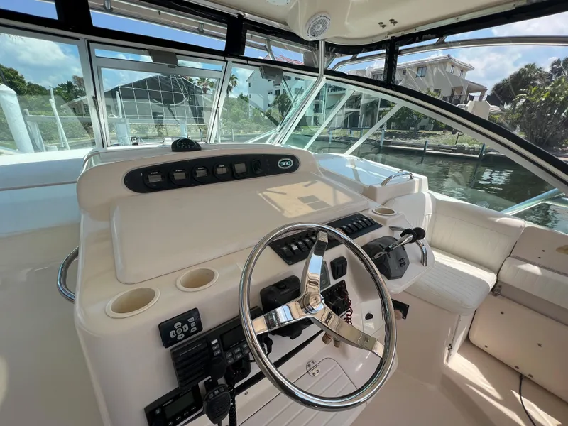 Slide: The Image of 2006 Grady-White 360 Express helm with steering wheel and control panel. - 11