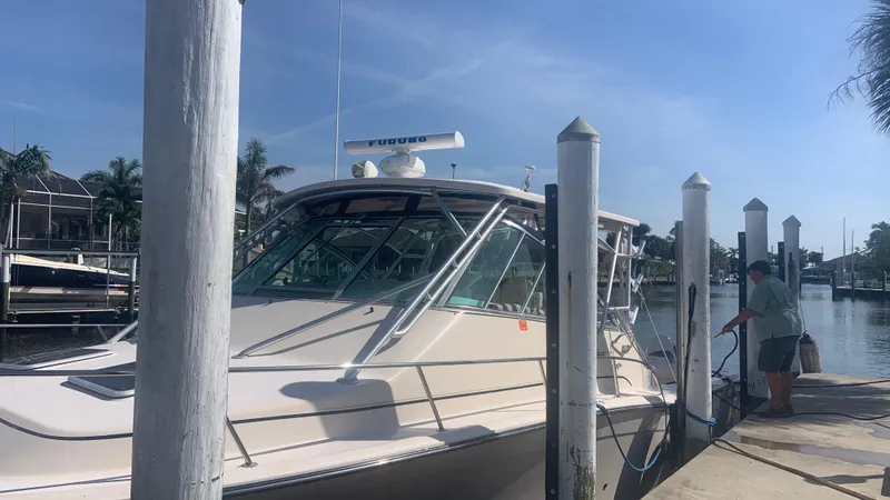 Slide: The Image of 2006 Grady-White 360 Express boat docked at marina under clear blue sky. - 13
