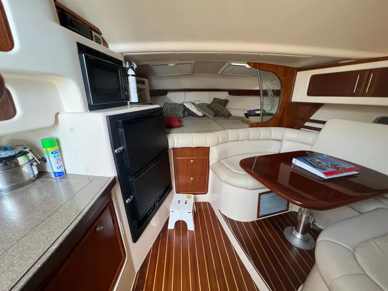 Slide: The Image of Interior of 2006 Grady-White 360 Express boat with cozy seating and wooden accents. - 15