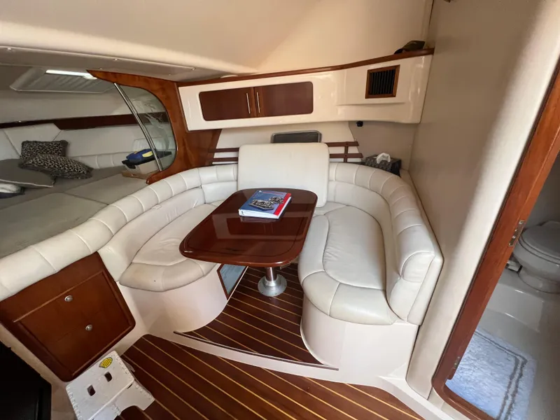 Slide: The Image of 2006 Grady-White 360 Express cabin with white leather seating and wooden accents. - 23