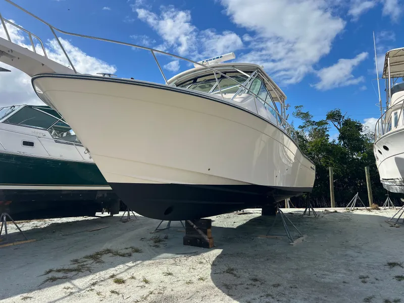 Slide: The Image of 2006 Grady-White 360 Express boat on land under a clear blue sky. - 28